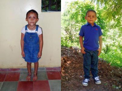 Two sponsored children, a girl in denim overalls and a boy in a blue shirt