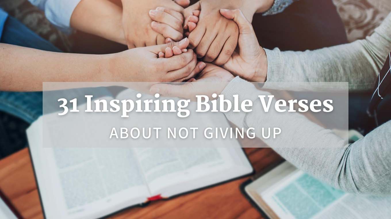 People holding hands in prayer over an open Bible