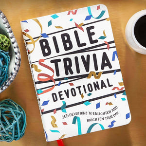 Bible Trivia Devotional book on a wooden surface with a cup of coffee and decorative items.