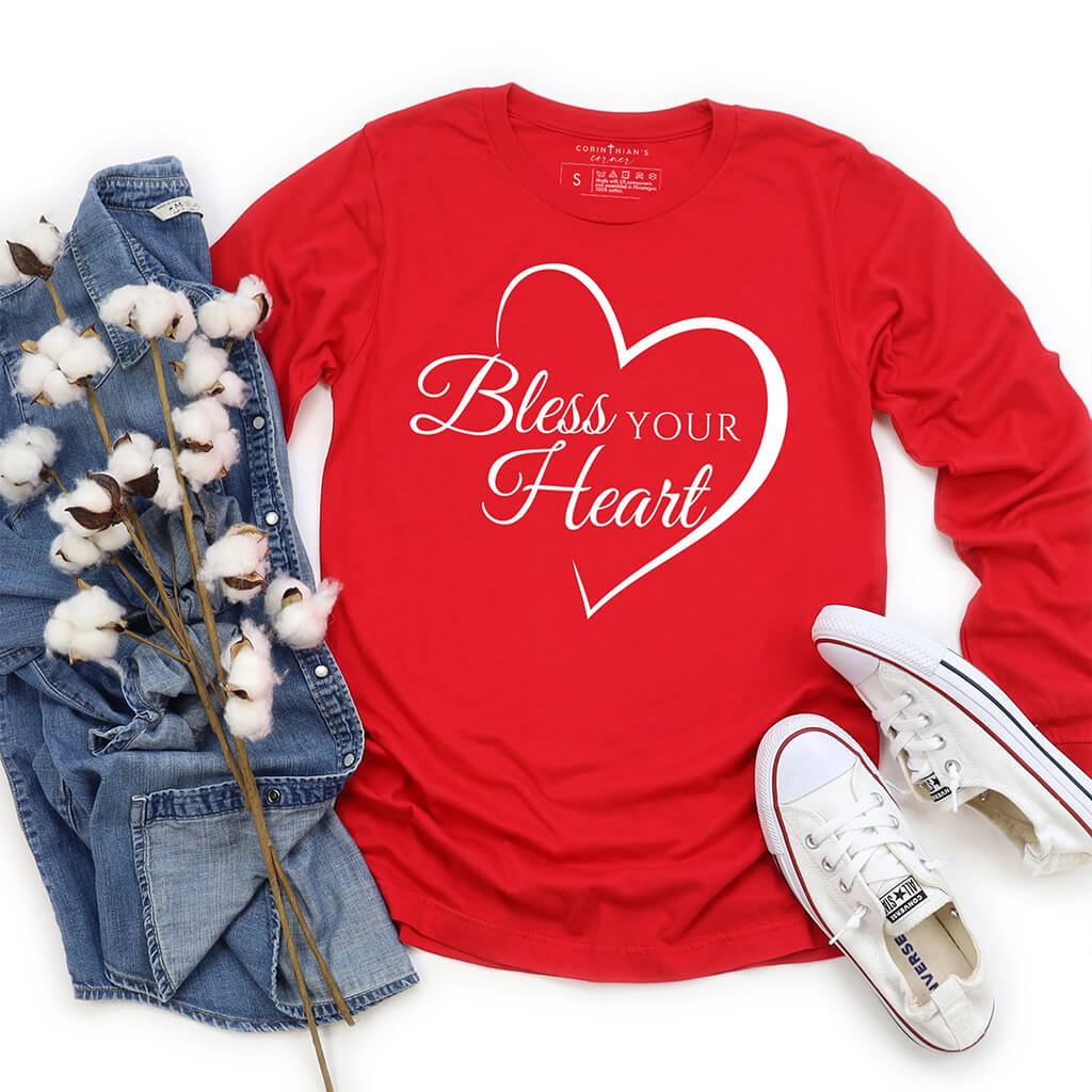 Red long sleeve shirt with a heart and text that reads bless your heart