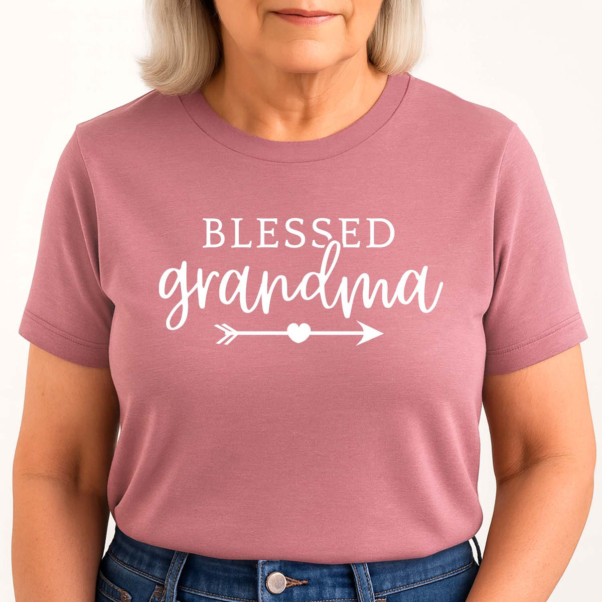 Woman wearing a pink t-shirt with 'Blessed Grandma' text on a white background