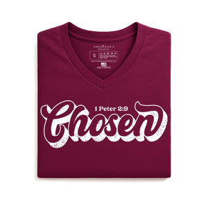 Folded maroon t-shirt with 'Chosen' text on a white background