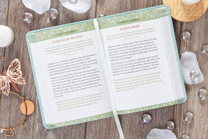 Open book on a wooden surface with decorative items around