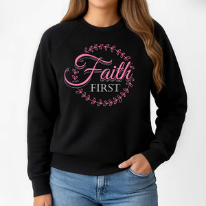 Black sweatshirt with 'Faith First' text in a white and pink screenprint