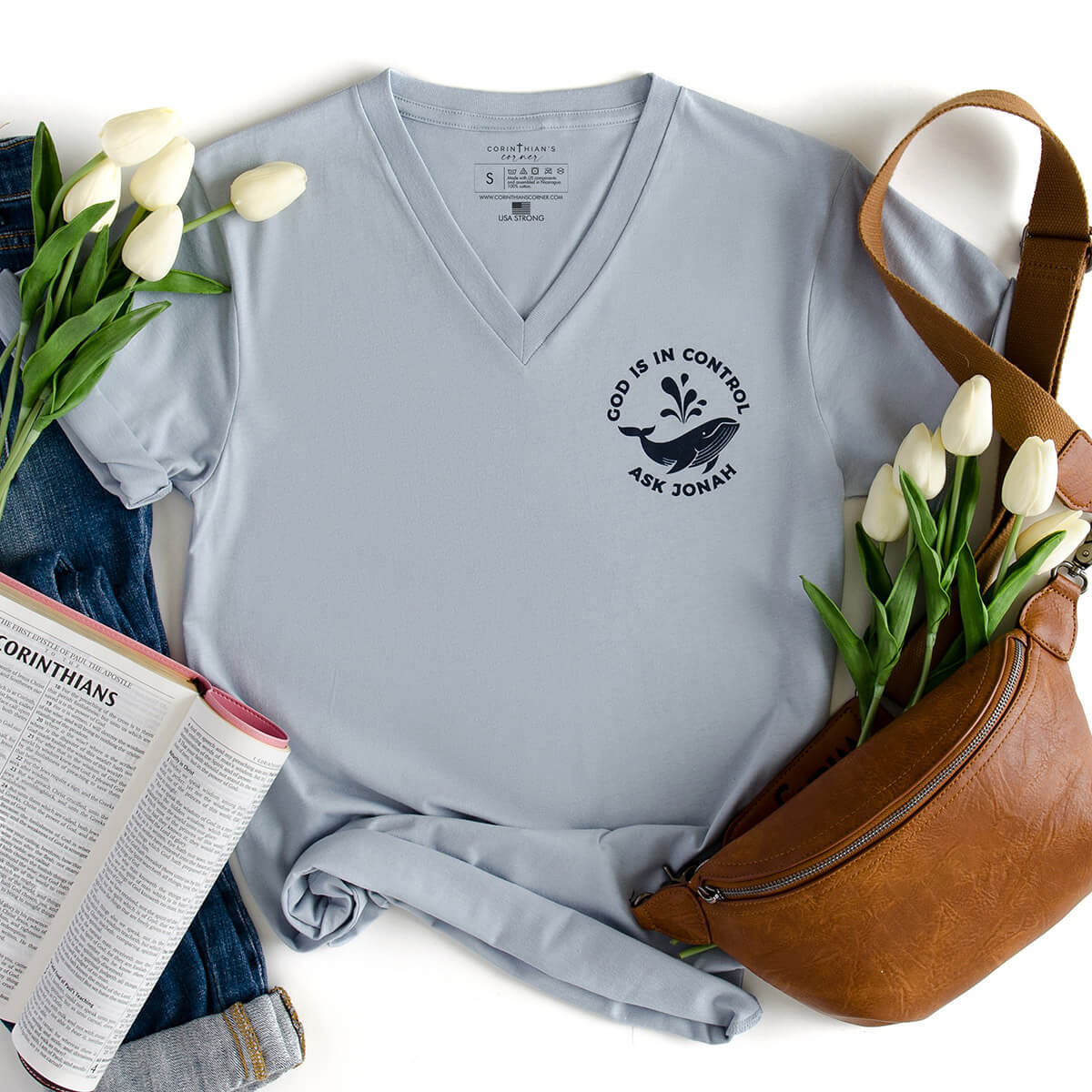 God is in control ask jonah whale design on a light blue v-neck shirt