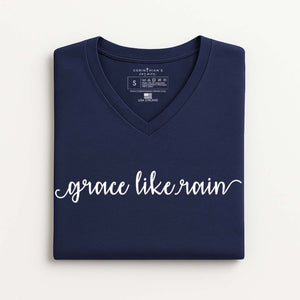 Folded navy blue V-neck t-shirt with 'grace like rain' text on a white background