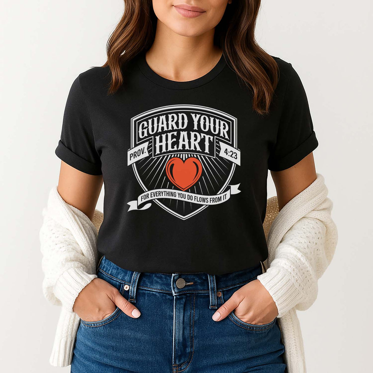Woman wearing a black t-shirt with 'Guard Your Heart' design inspired by Proverbs