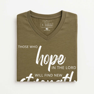 Folded olive green t-shirt with Christian quote on a white background