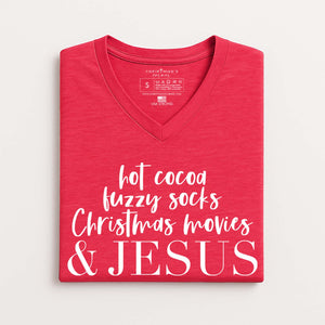 Folded red V-neck t-shirt that reads hot cocoa, fuzzy socks, Christmas movies, and Jesus