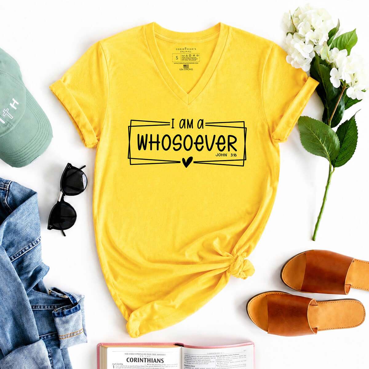 Yellow t-shirt with 'I am a WHOSOEVER' text, surrounded by casual items on a white background
