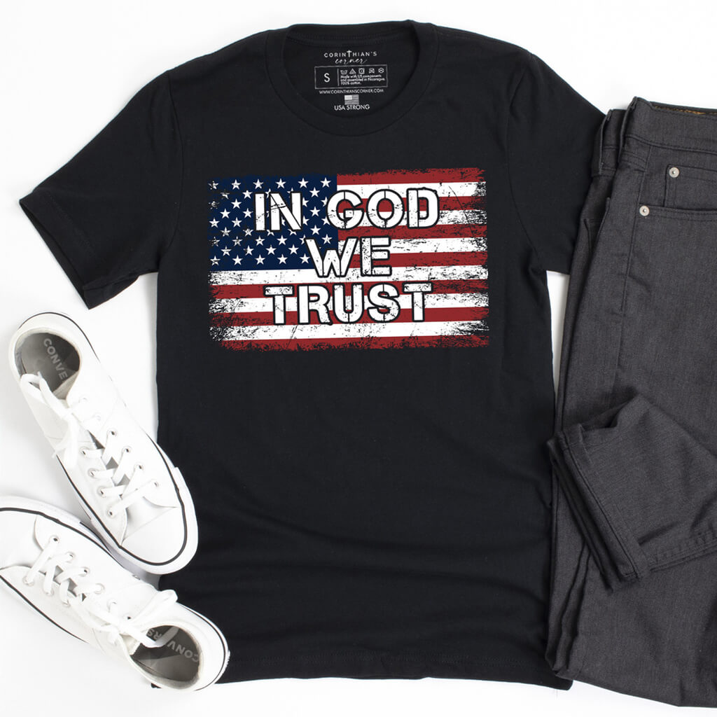 Men's Christian shirt that boldly states "In God We Trust" superimposed on a full color American flag