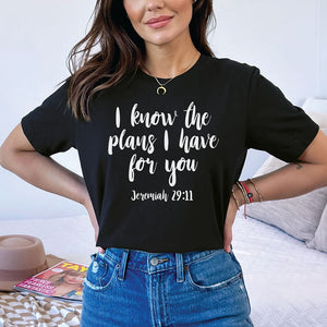 Woman with hands at her hips wearing jeans and an I know the plans I have for you shirt