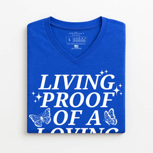 Blue V-neck t-shirt with butterfly graphics and white text that reads living proof of a loving God