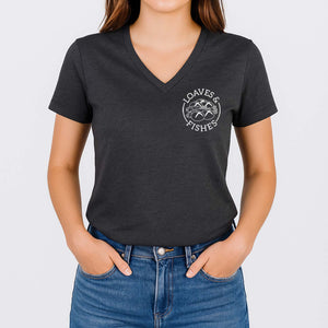 Person wearing a dark gray t-shirt with 'Loaves & Fishes' logo on a plain background
