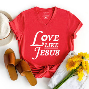 Love like Jesus graphic v-neck shirt styled with flowers, sandals, and a summer hat