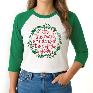 Green and white baseball shirt with Christmas design and text on a plain background