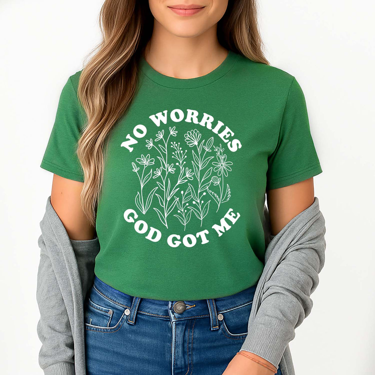 Young lady wearing a green t-shirt with 'No Worries God Got Me' text and floral design.