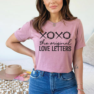Light mauve t-shirt that reads XOXO the original love letters on a young model
