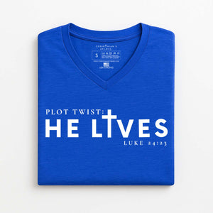Blue V-neck t-shirt with 'PLOT TWIST: HE LIVES' text on a white background