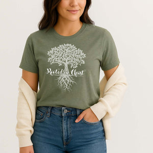 Closeup of a model wearing the green rooted in Christ graphic t-shirt
