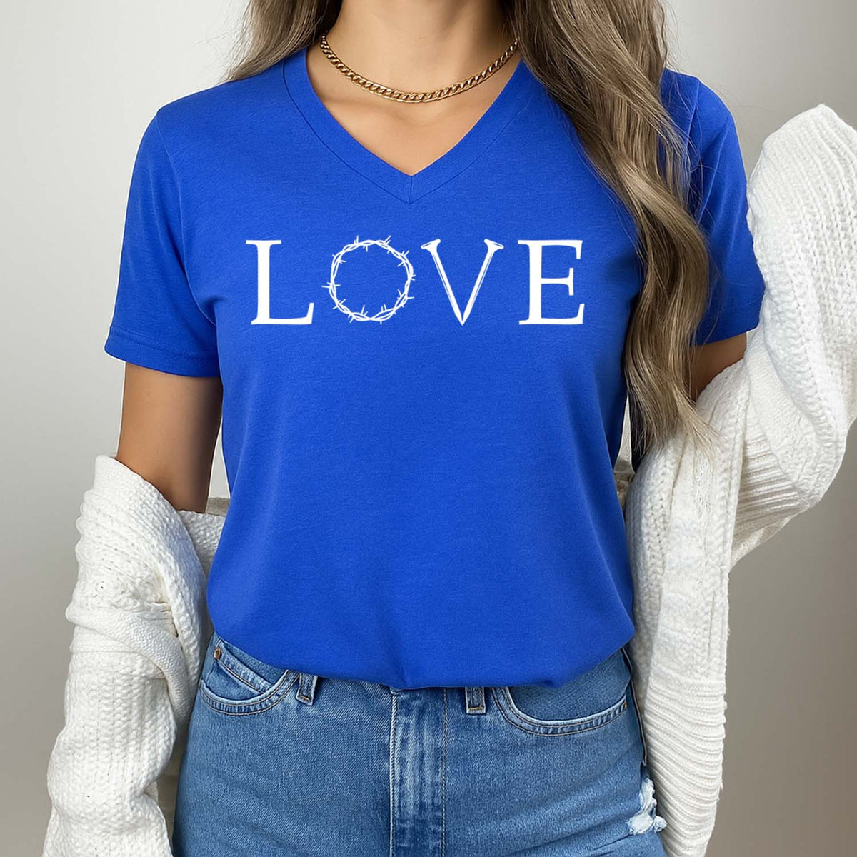 Person wearing a blue t-shirt with 'LOVE' printed on it against a neutral background