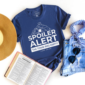 Graphic Easter t-shirt for women that reads spoiler alert the tomb was empty