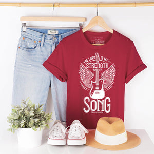 My strength and my song graphic Christian t-shirt hanging up with jeans
