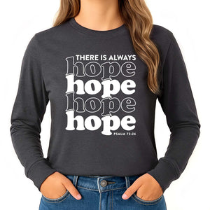 Girl wearing a 'there is always hope' shirt with Psalm 73:26 on a dark grey long sleeve shirt