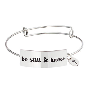 Stainless steel Christian bangle bracelet on white background