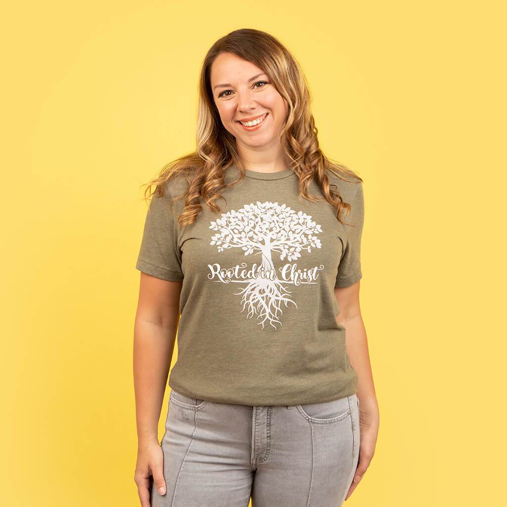 Olive green Christian top with a graphic tree of life design and rooted in Christ text