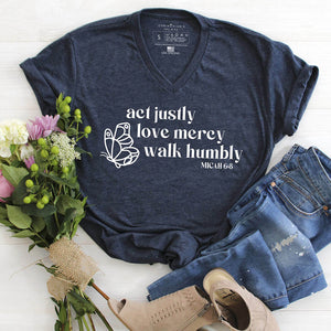 "Act justly, love mercy, walk humbly" design with a butterfly on a navy V-neck shirt