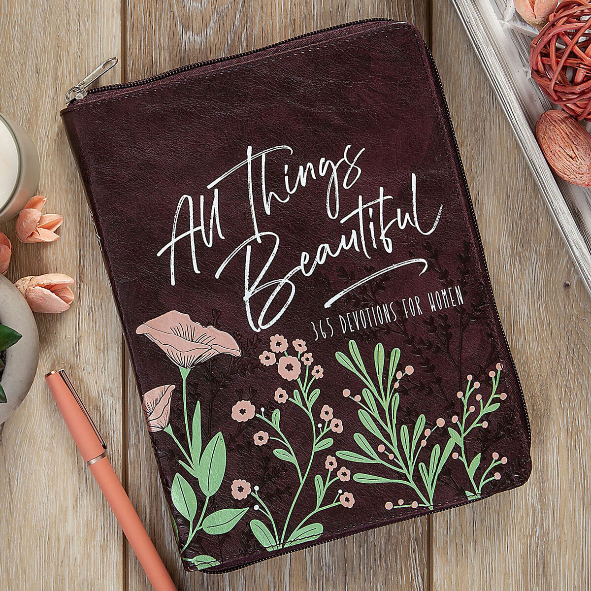 Brown pouch with floral design and text on a wooden surface