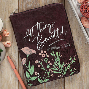 Brown pouch with floral design and text on a wooden surface