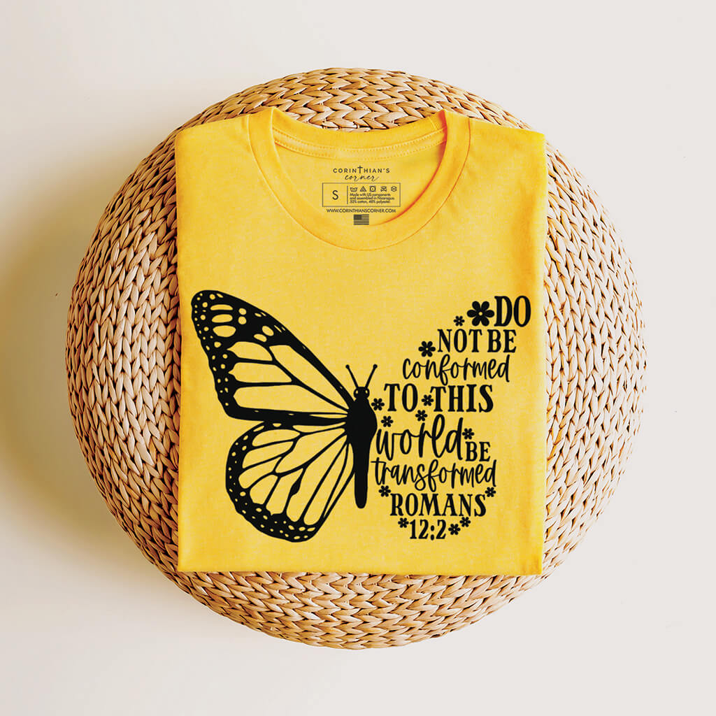 Yellow shirt with Bible passage from Romans 12:2 that reads be transformed