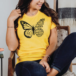 Woman sitting in a lounge chair wearing the Be Transformed Romans 12:2 shirt