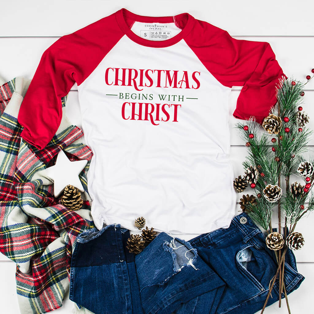 Red 3/4 sleeve raglan shirt with red and green Christmas graphic design