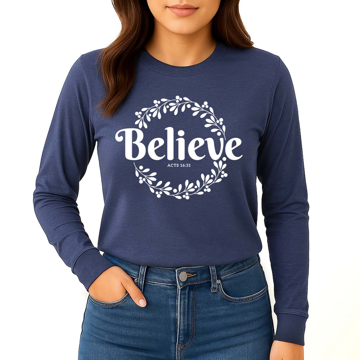 Navy long-sleeve shirt with 'Believe, Acts 16:31' on a young woman standing against a white background
