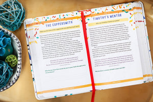 Open Bible trivia book with colorful text and a red ribbon on a wooden surface