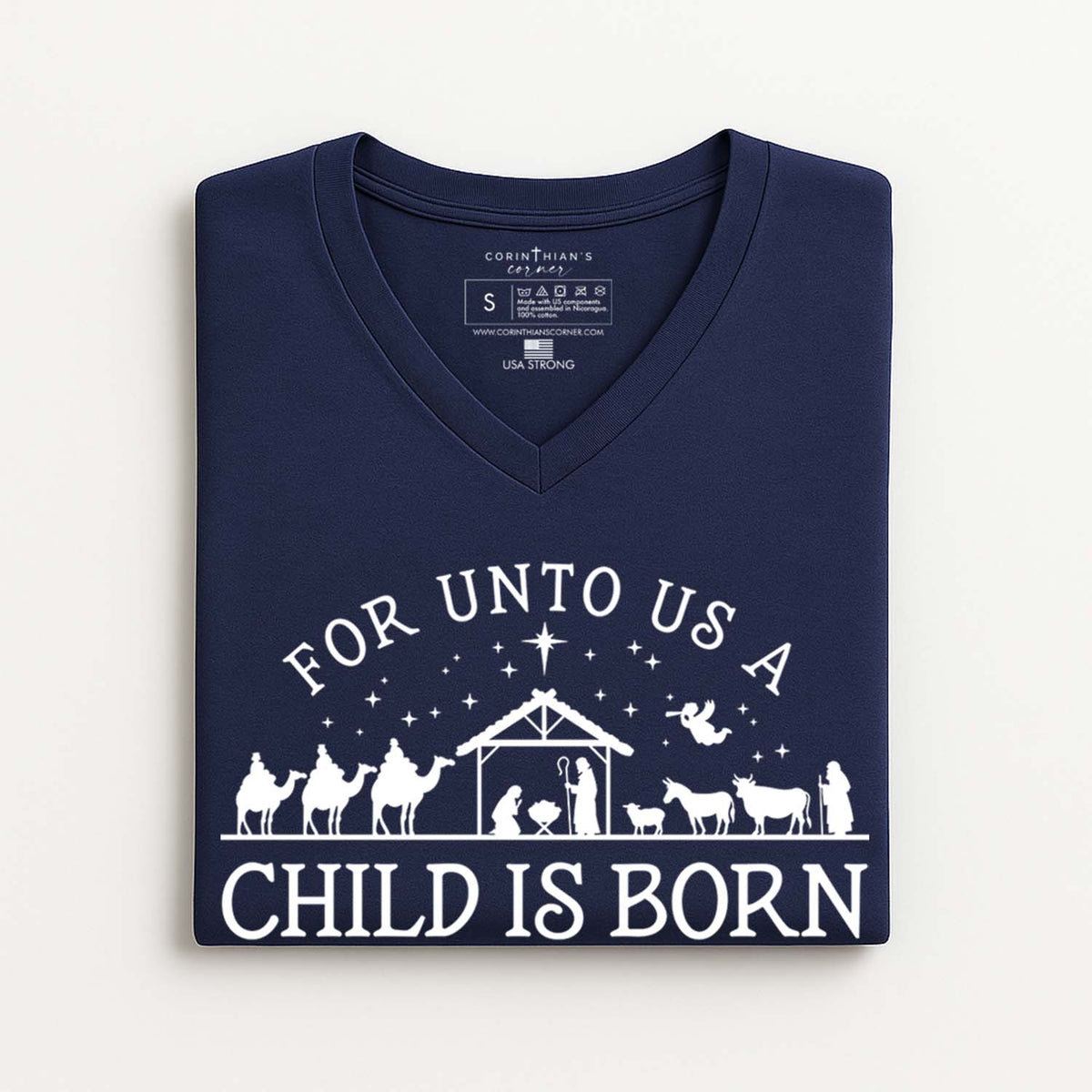 Navy blue V-neck t-shirt with white nativity scene design and text on a white background
