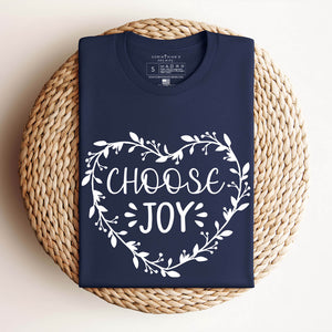 Folded choose joy t-shirt in navy on a woven basket