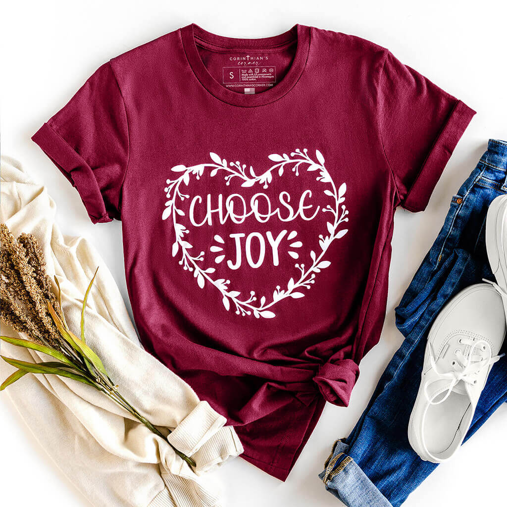 Maroon tee shirt with heart made of flowers and a "choose joy" inscription