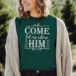 Female model wearing a green oh come let us adore Him Christmas t-shirt for Christians
