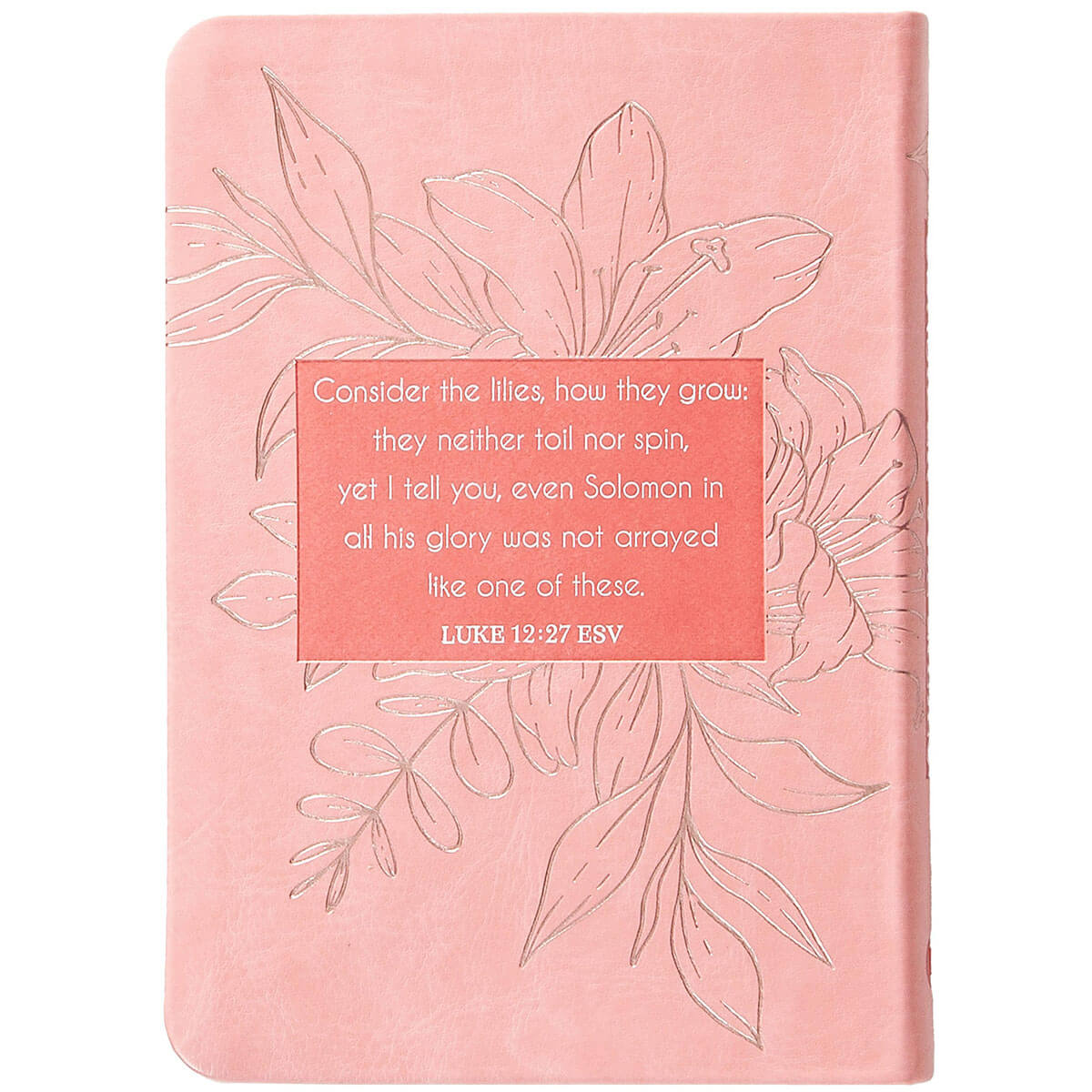 A pink hardcover notebook featuring embossed floral line art and a central coral-colored text block with a Bible verse from Luke 12:27 ESV.
