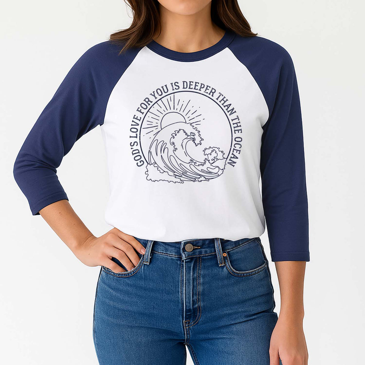 Model wearing a blue and white baseball shirt with a wave design that reads God's love for you is deeper than the ocean