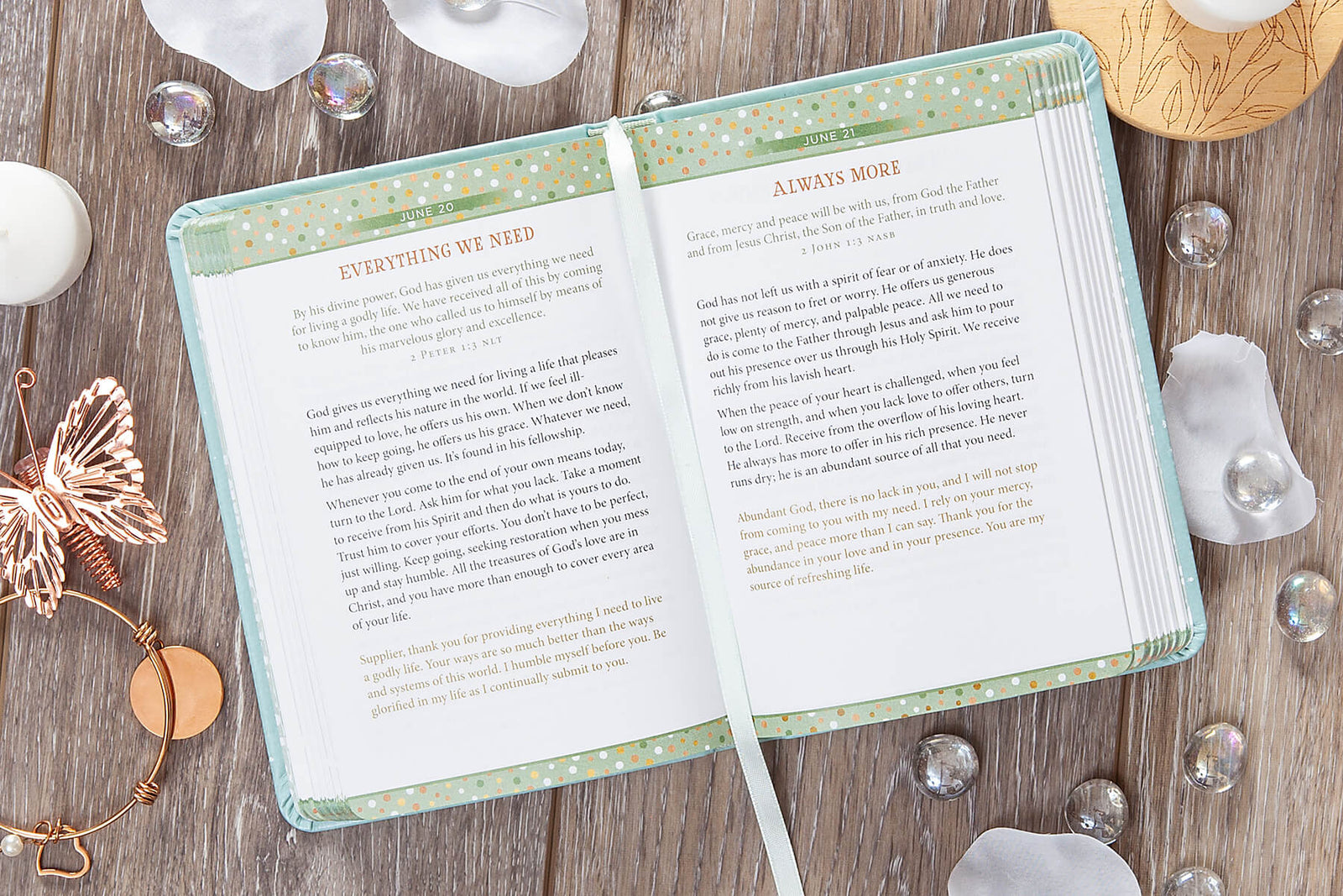 Light blue notebook with 'Detox for the Soul' text on a wooden surface with decorative items.