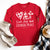 Red Christmas shirt with scripture from John 14:27 that says love, joy, and eternal peace