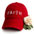 Red dad hat with white embroidery that reads faith