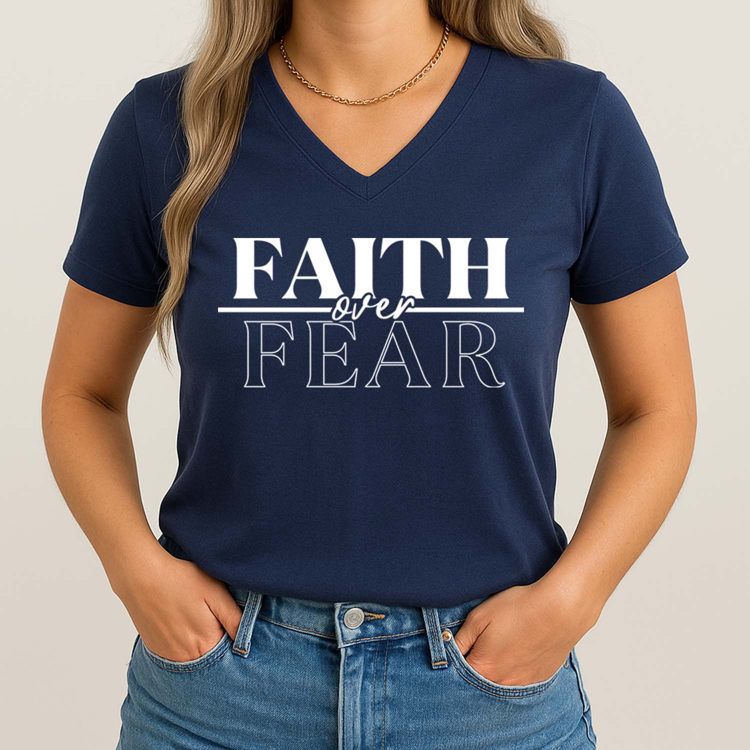 Bold faith over fear graphic on a navy blue v-neck designed to inspire confidence in God's power