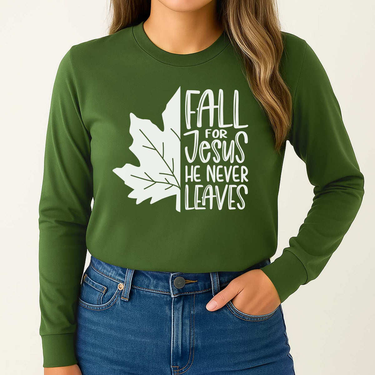 Green shirt with 'Fall for Jesus He Never Leaves' text and leaf design on a young woman