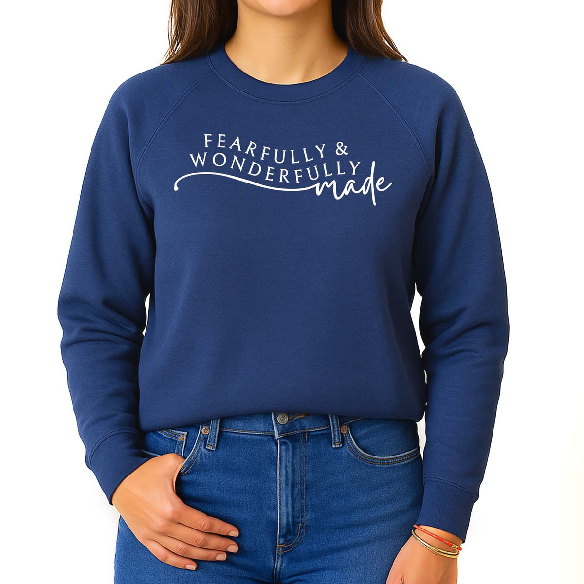 Girl wearing a blue sweatshirt with 'Fearfully & Wonderfully Made' text against a white background